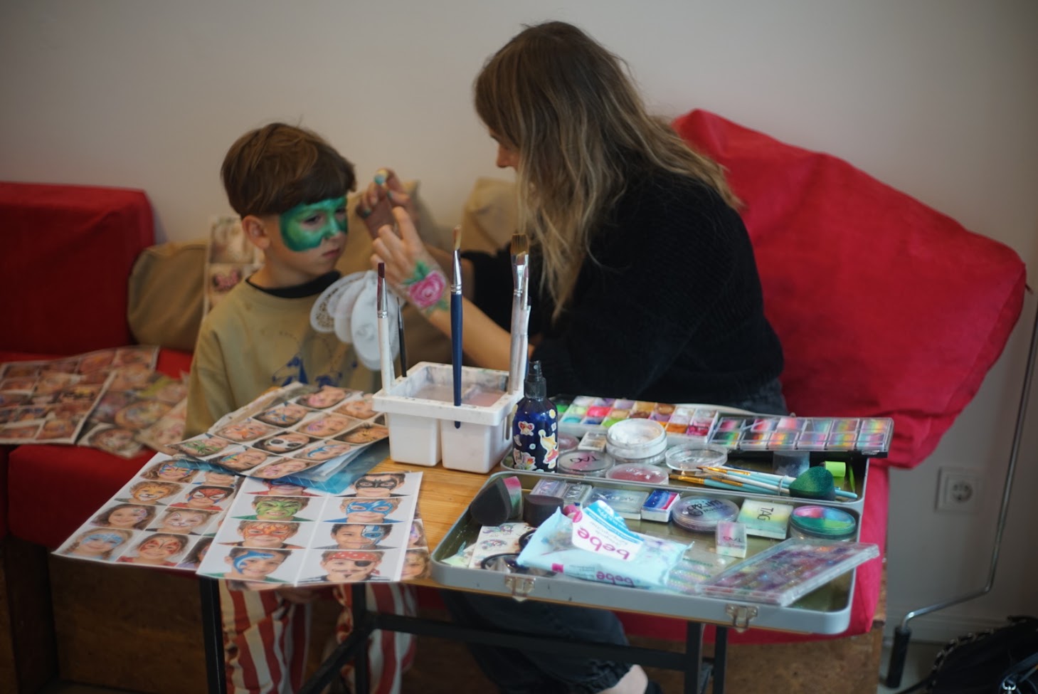 Children gathered around a table making art in the studio